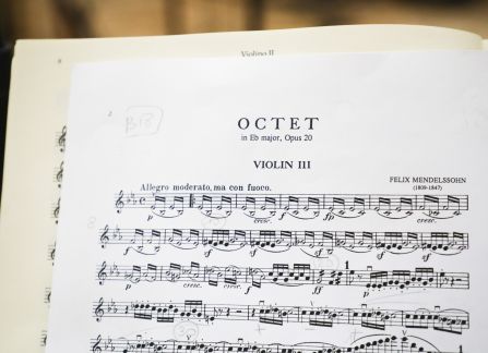 A photograh. A sheet music on a stand, titled octet